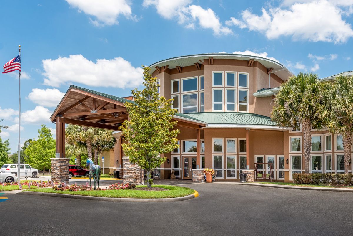 A welcoming hotel entrance with modern architecture and well-maintained landscaping.