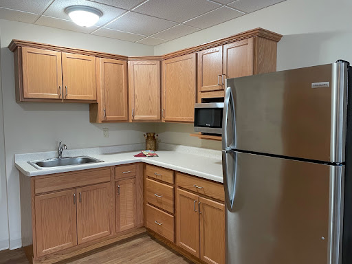 A modern kitchen featuring wooden cabinets and stainless steel appliances.