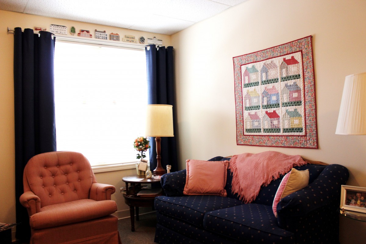 Cozy living room with a couch, armchair, and decorative elements.