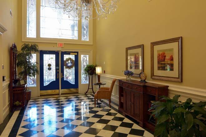 Elegant lobby with checkered flooring and decorative elements.