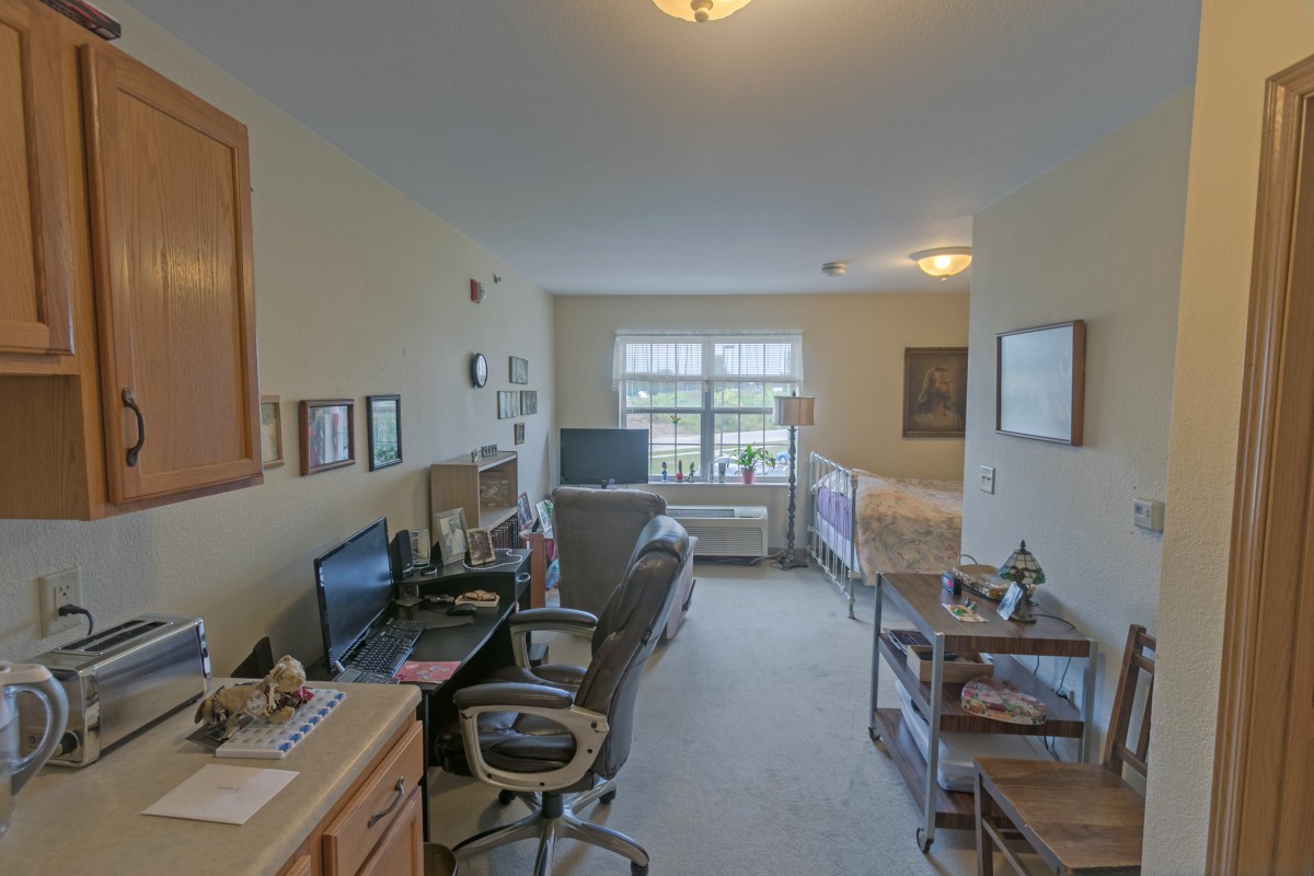 A cozy living space with a combined workspace and sleeping area.