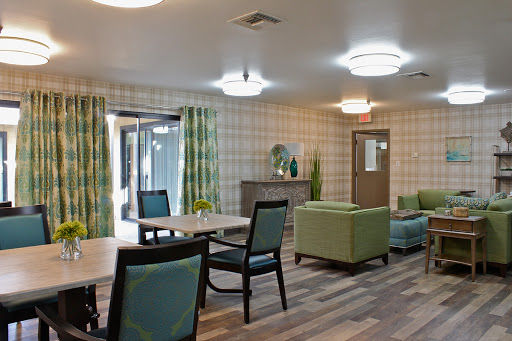 A modern lounge area featuring comfortable furniture and bright decor.