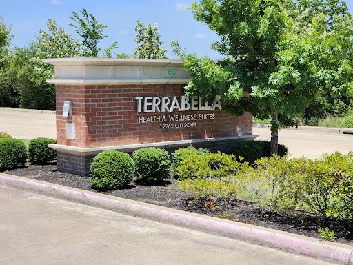 The entrance sign of Terrabella, showcasing a well-maintained landscape.