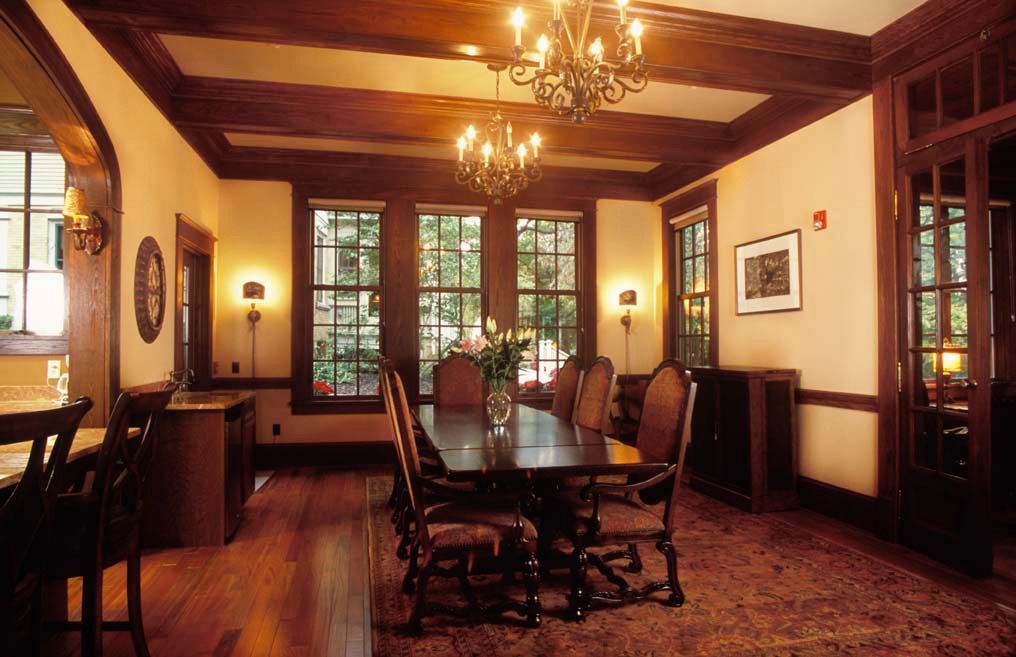 A classic dining room with wooden furniture and elegant chandeliers.
