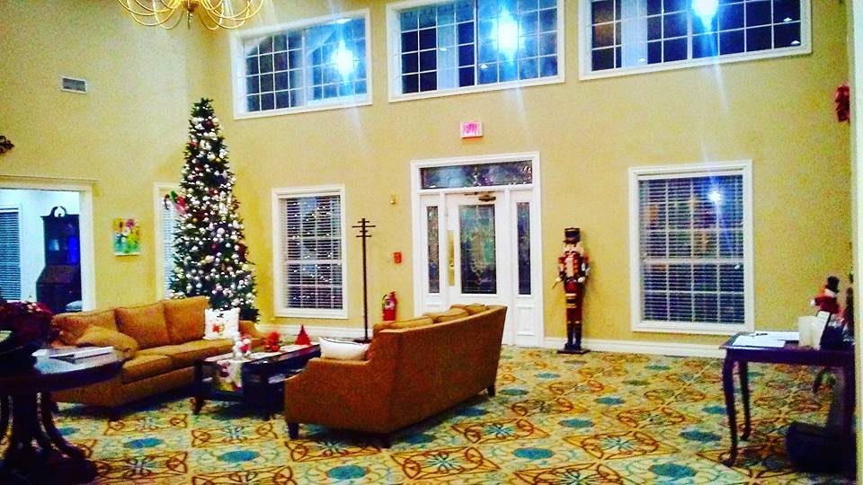 A festive indoor setting with a decorated Christmas tree, cozy sofas, and holiday decorations.