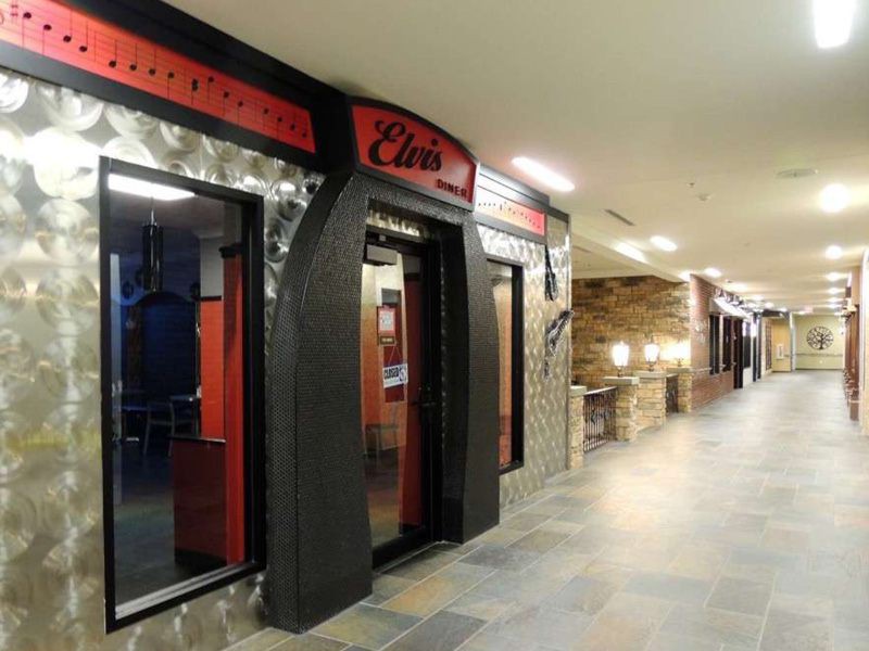 A view of a restaurant entrance in a well-lit corridor.