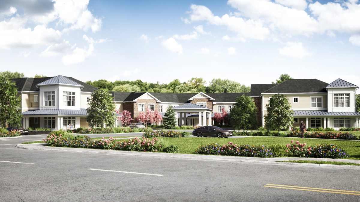 A scenic view of a large residential building with a landscaped frontage and road.
