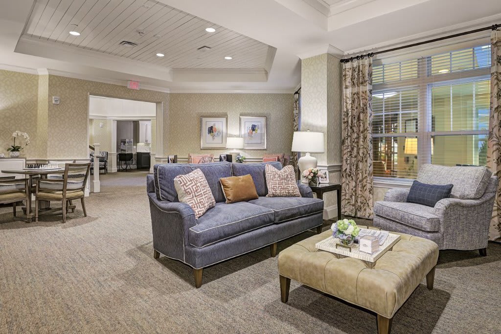 A cozy and elegantly designed living room with a comfortable sofa, stylish coffee table, and warm lighting.