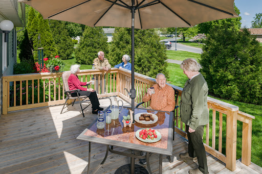 A cheerful gathering with friends enjoying a meal on the deck.