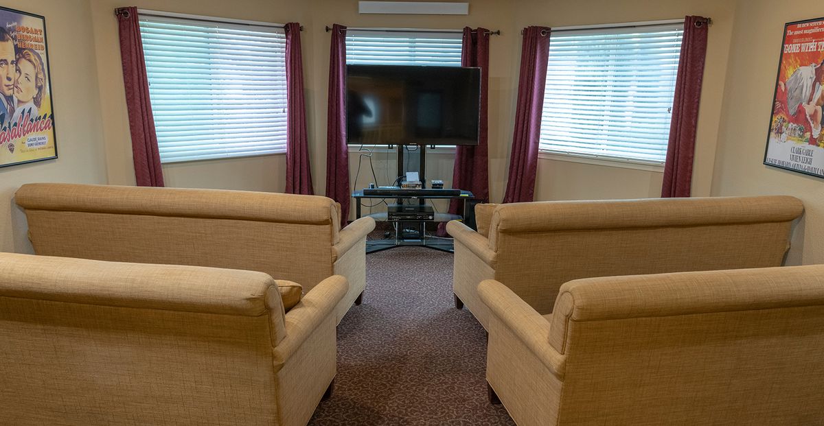 A cozy living room setup with armchairs facing a television.