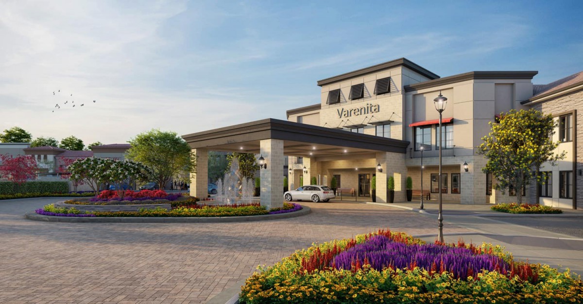 A welcoming view of the Marriott hotel's entrance, featuring well-maintained landscaping and colorful flower arrangements.