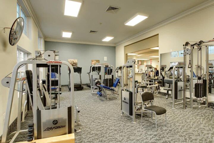 A well-equipped gym with various exercise machines and a spacious layout.