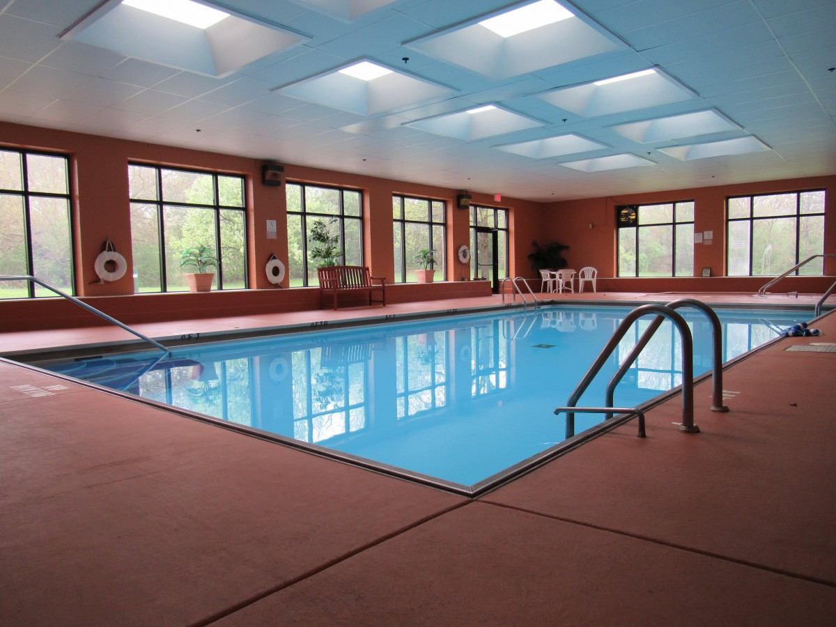 Spacious indoor swimming pool with natural lighting.