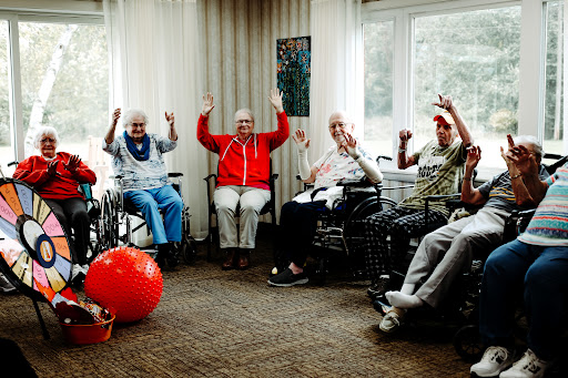 Residents participate in a fun group activity at a care facility, showcasing joy and engagement.