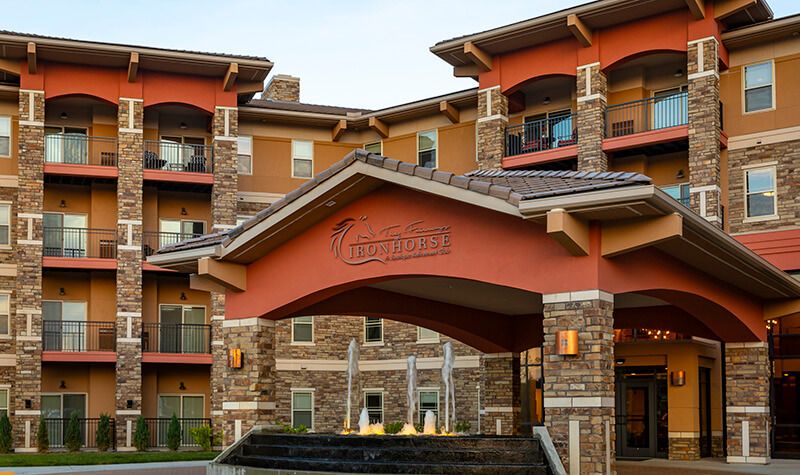 A residential building entrance with a fountain and stone accents.