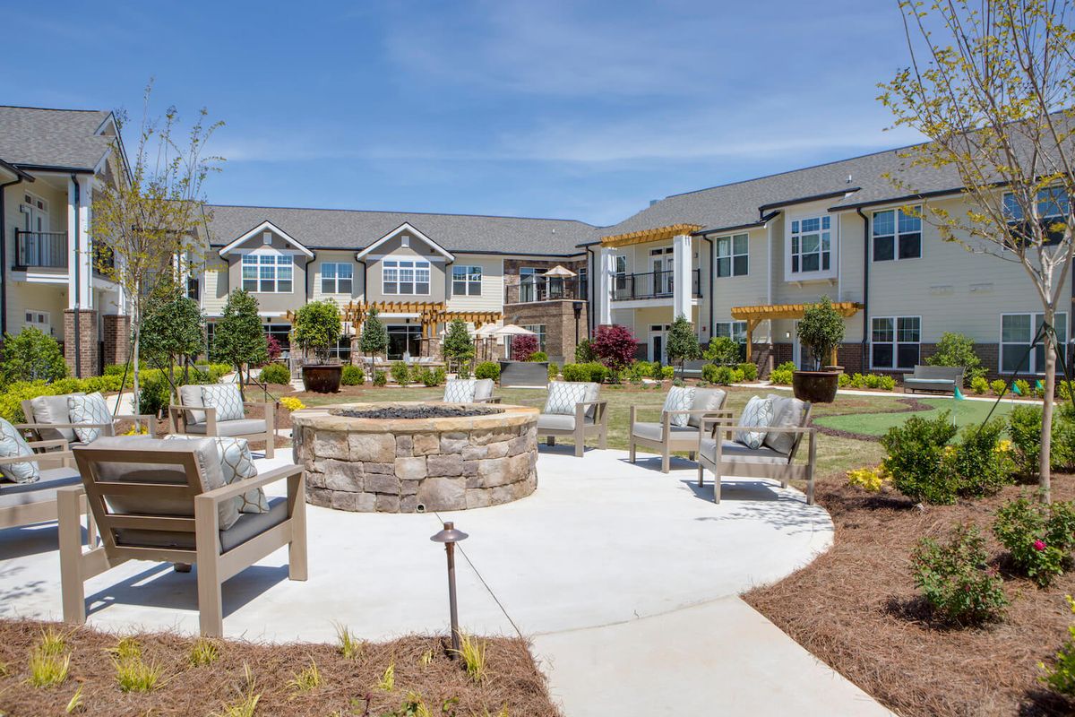 An outdoor seating area with a fire pit at an apartment complex.