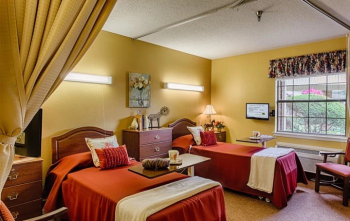 A cozy shared bedroom with twin beds and warm lighting.