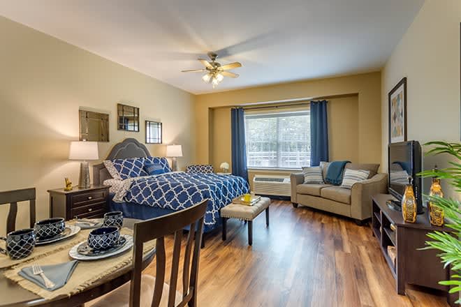A cozy bedroom with elegant furnishings and natural lighting.