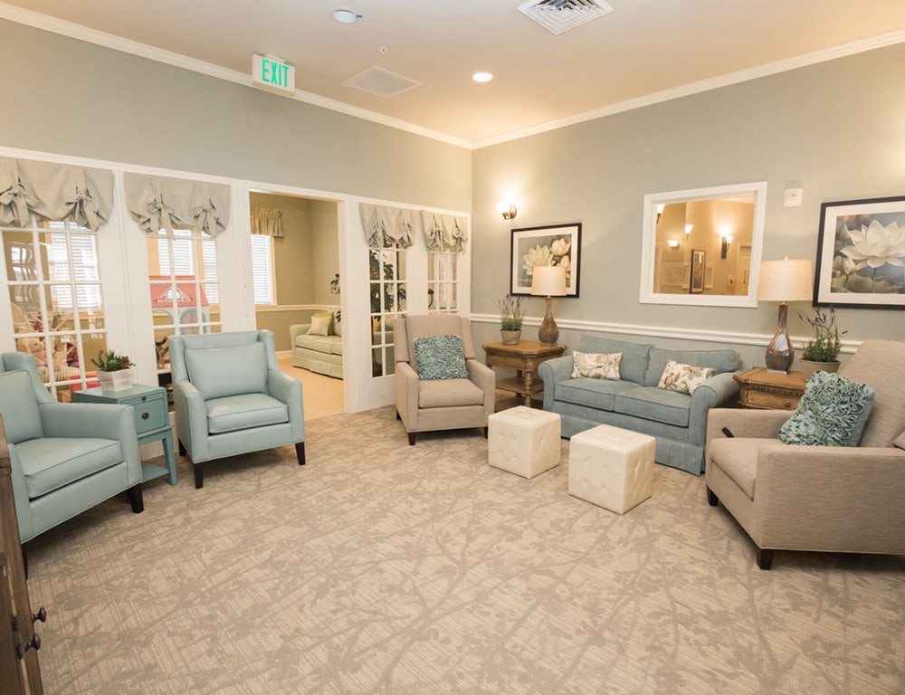 A cozy living room with sofas, armchairs, and stylish decor.