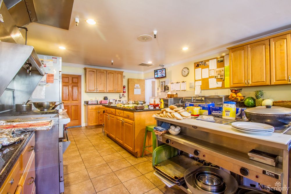 A busy commercial kitchen with various cooking equipment and utensils.