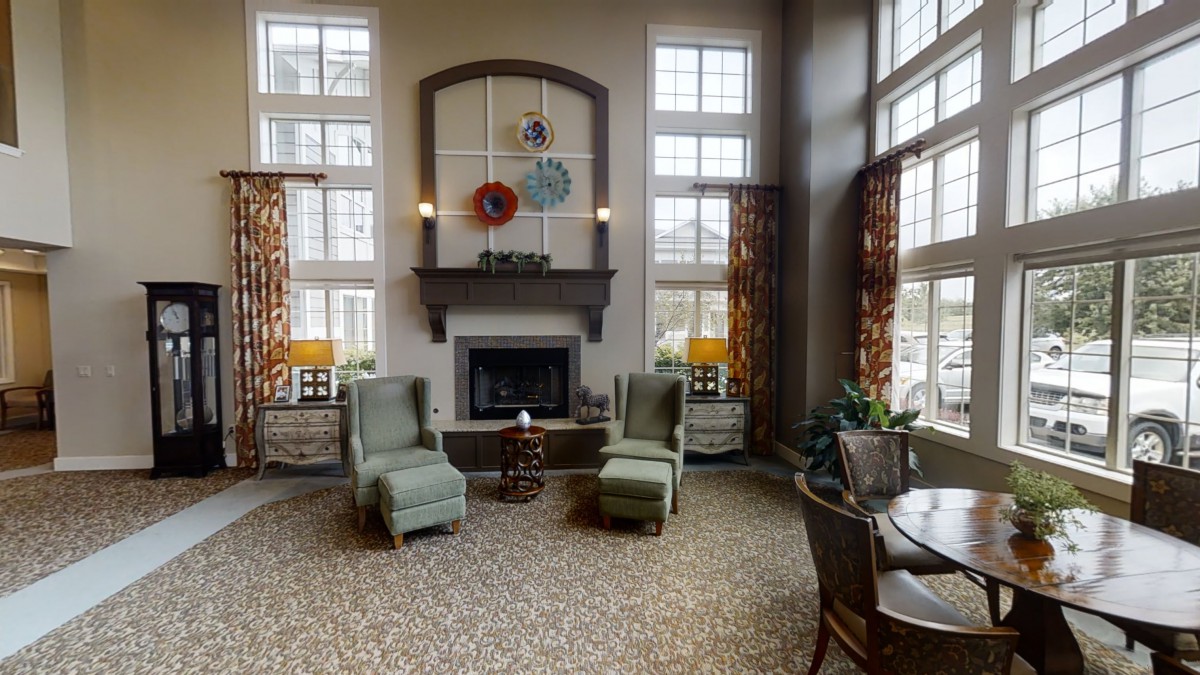 A cozy living room with a fireplace and comfortable seating.