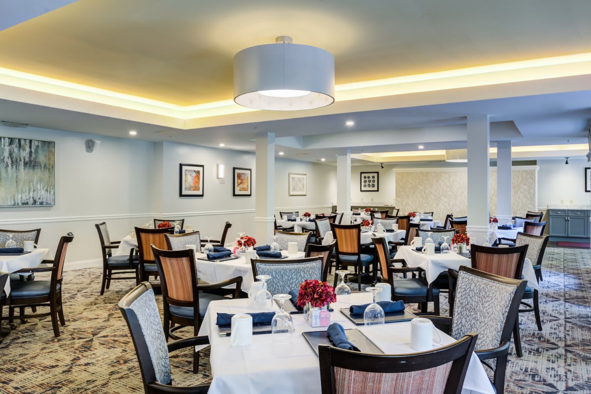 An elegant restaurant dining area with neatly arranged tables and chairs, ready for guests.