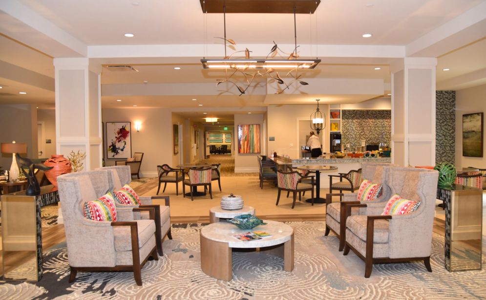 A modern lounge area featuring comfortable seating, a central coffee table, and stylish lighting.