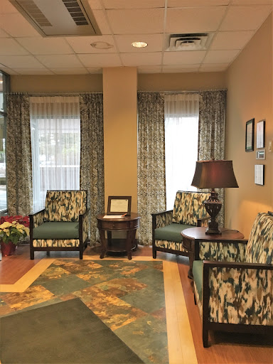 A cozy waiting area featuring comfortable chairs and warm lighting.