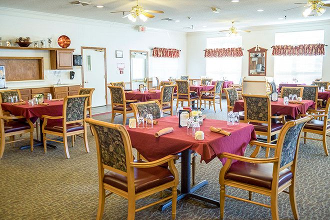 A cozy dining area with tables and chairs set for guests.