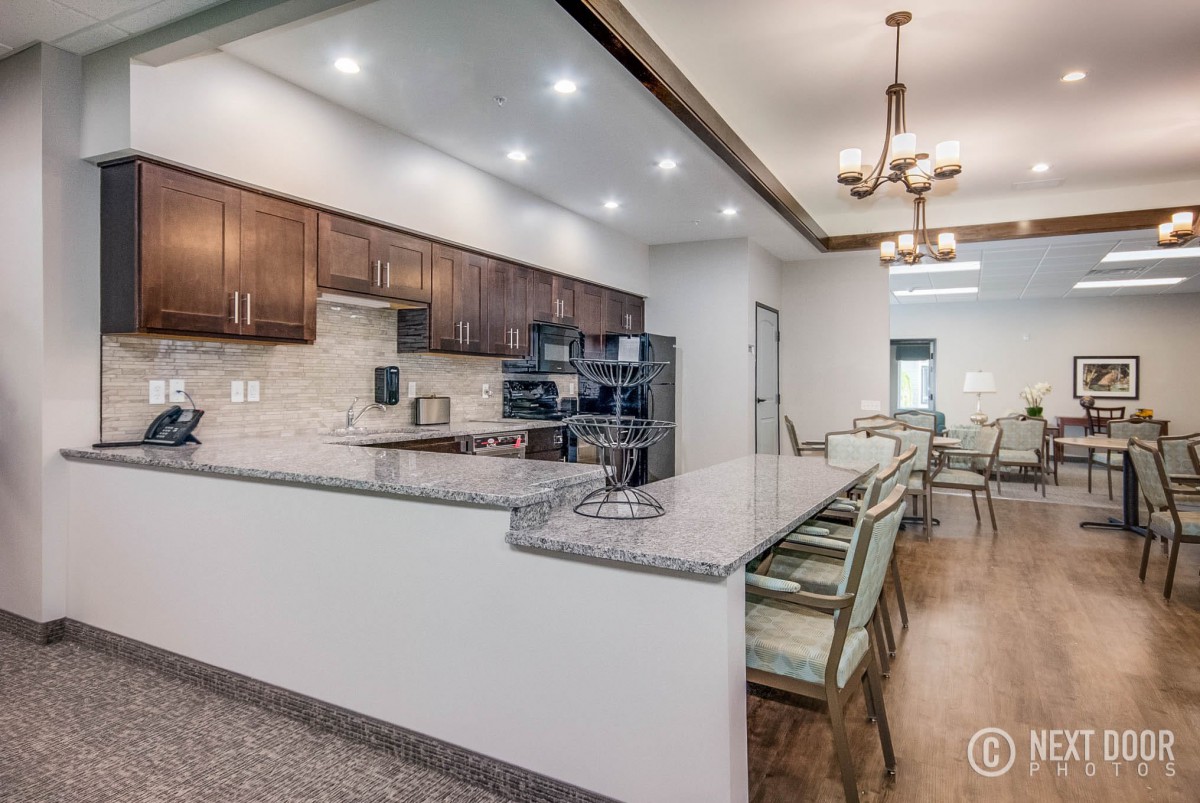 A modern kitchen interior with a sleek countertop and dining area.