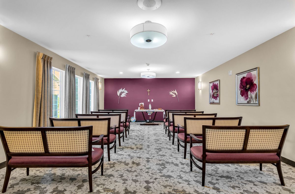 A neatly arranged conference room with chairs facing a table, set up for a meeting or presentation.