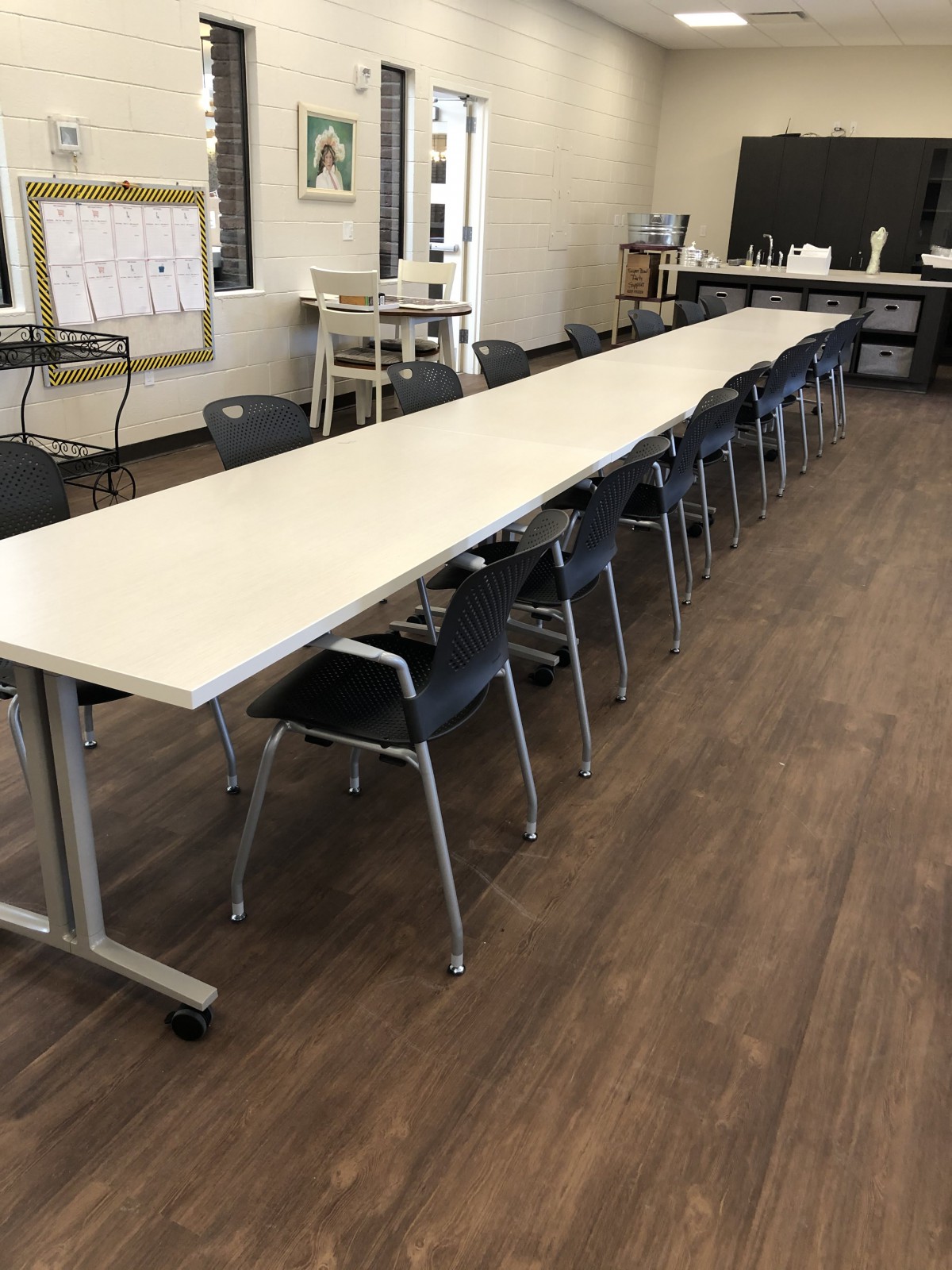 A long conference table with chairs in an office setting.