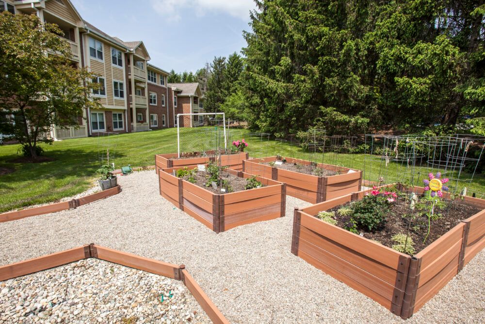 A community garden with raised beds located in a residential area.