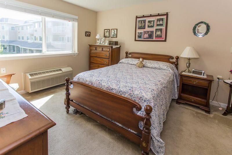 A cozy bedroom with wooden furniture and a large bed.