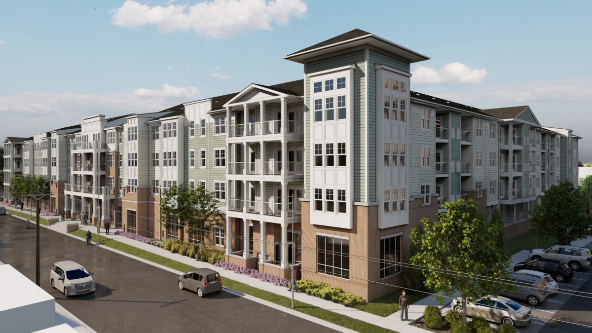 A modern apartment building with multiple stories and a sleek architectural design, situated in an urban area.