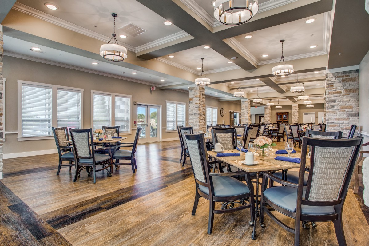 An elegant dining area with well-arranged seating and stylish chandeliers.