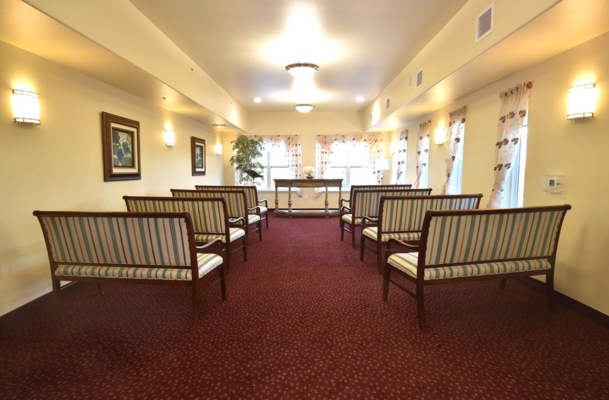 A well-lit room with arranged seating and decor.
