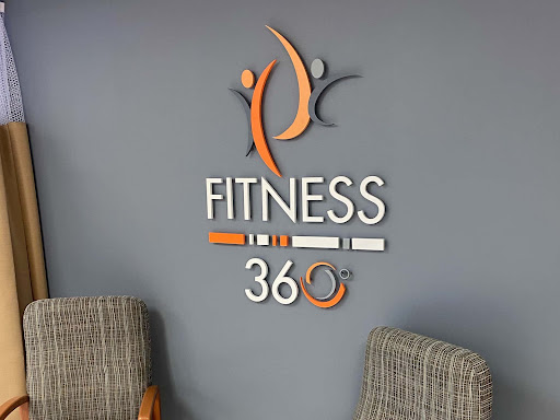 The Fitness 360 logo displayed prominently in a modern gym setting.