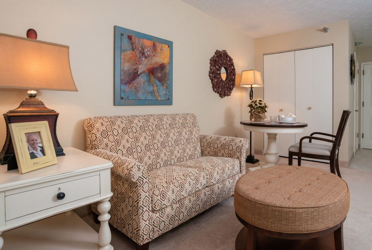 A cozy living room with a patterned sofa and stylish decor.