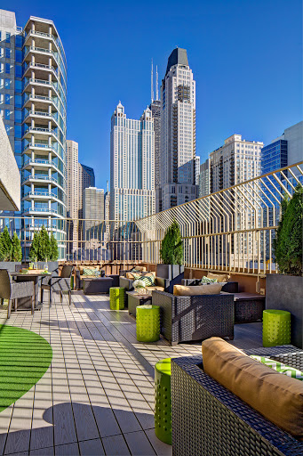 A stunning rooftop lounge with a modern aesthetic, offering breathtaking views of the city skyline.