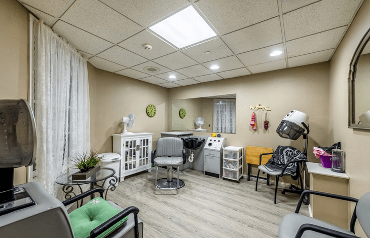 A well-organized hair salon with modern equipment and seating.