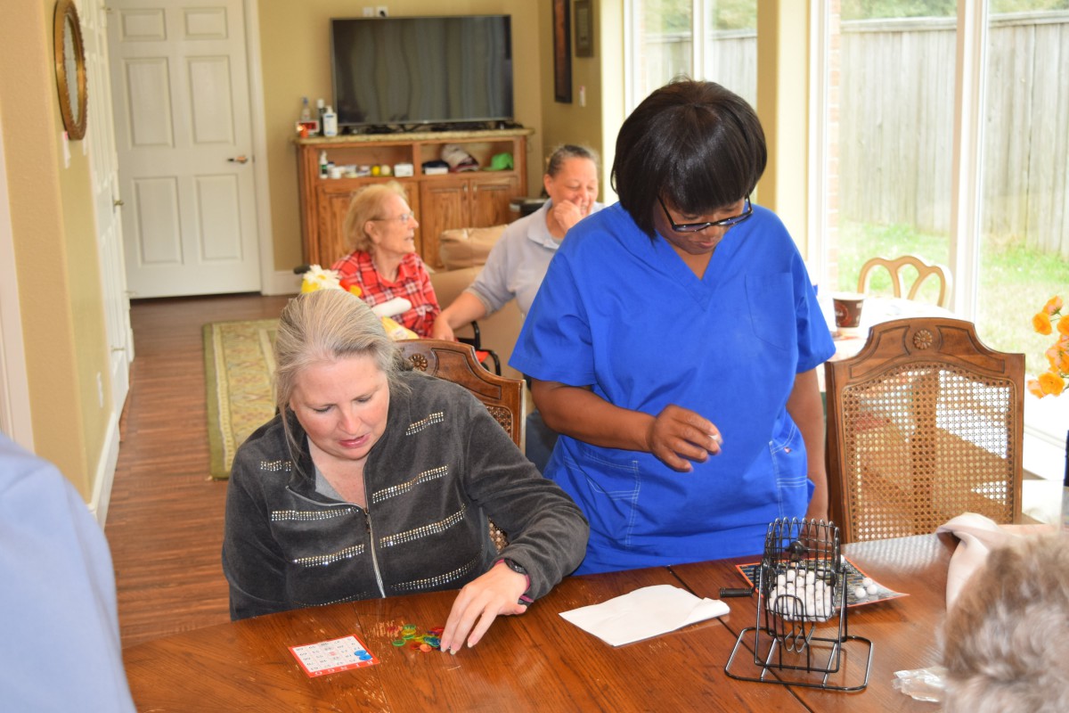 A caregiver assists seniors in a nursing home setting.