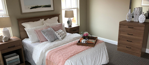 A beautifully arranged bedroom featuring soft bedding and a cozy atmosphere.