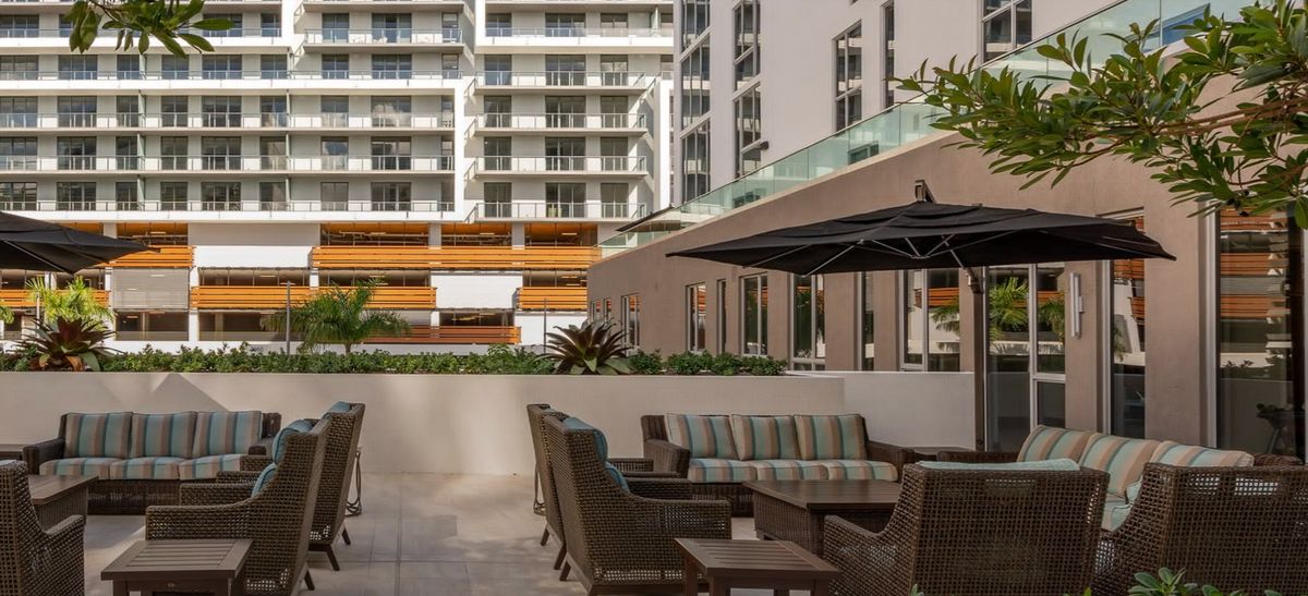 Modern outdoor seating area in an urban apartment complex.