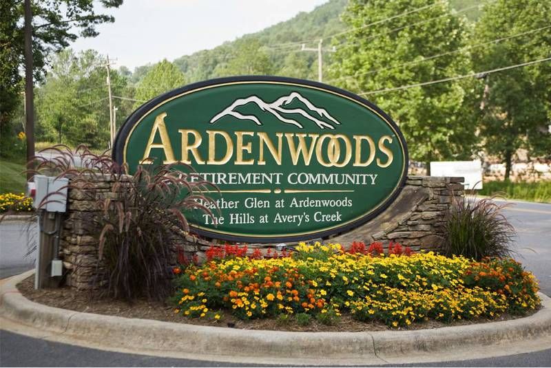 Entrance sign for Ardenwoods Retirement Community surrounded by colorful flowers.