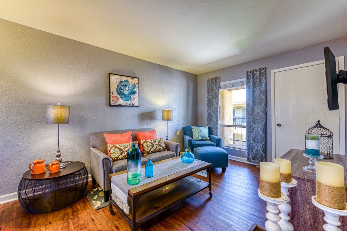 A modern living room with colorful accents and stylish furnishings.