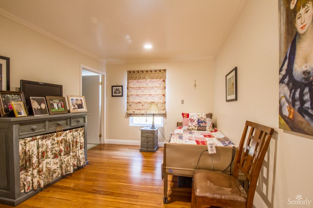 A cozy dining area with wooden floors, adorned with artwork and decorations.