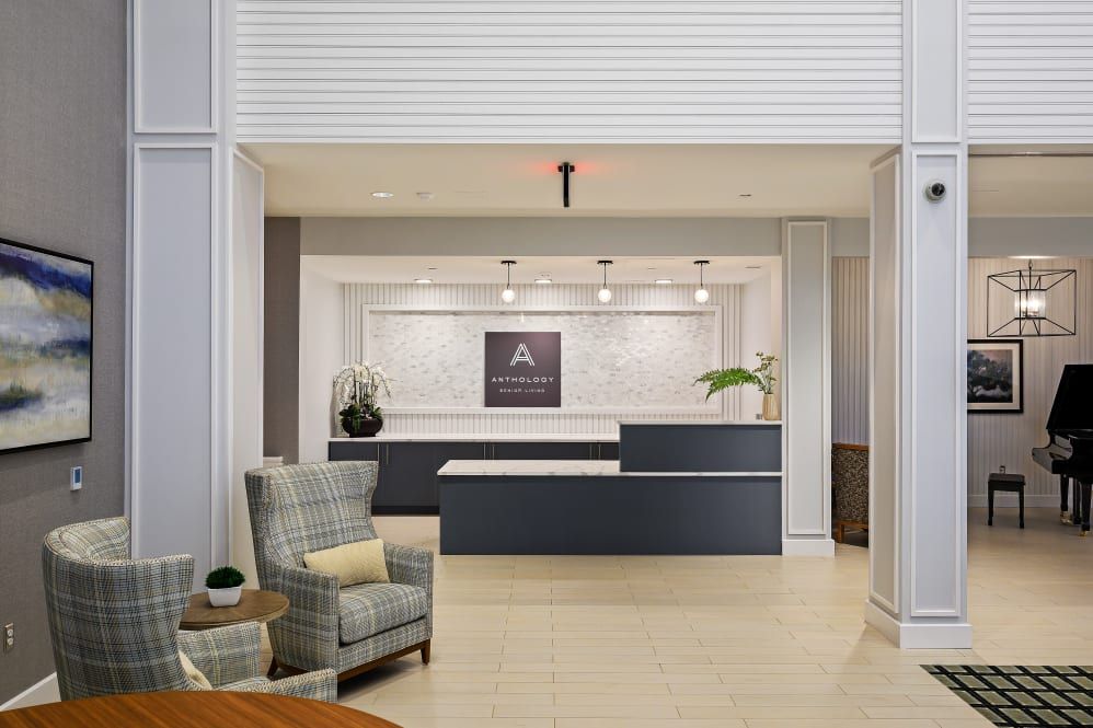 A modern hotel lobby with a stylish reception desk and comfortable seating.