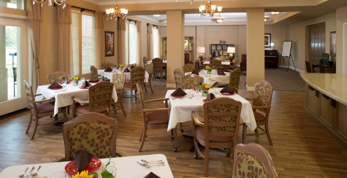 An elegantly decorated dining room with neatly arranged tables and chairs.
