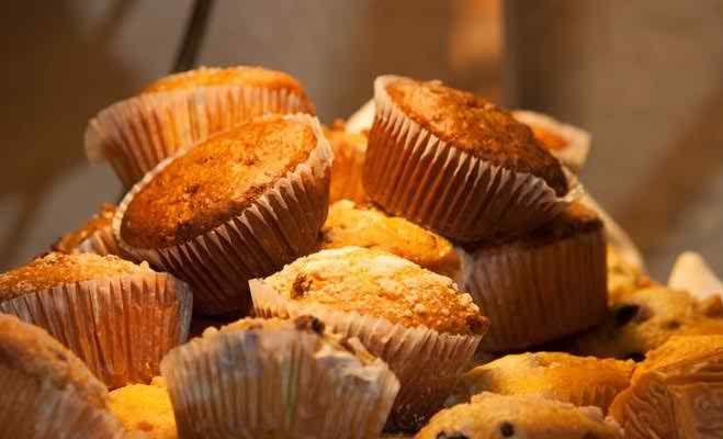 A delicious assortment of freshly baked muffins piled together.